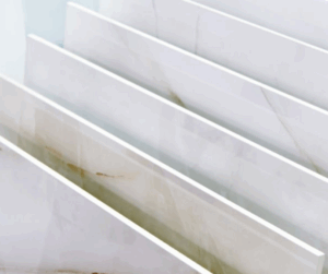 Close-up view of glossy, porcelain tiles arranged vertically in a showroom.