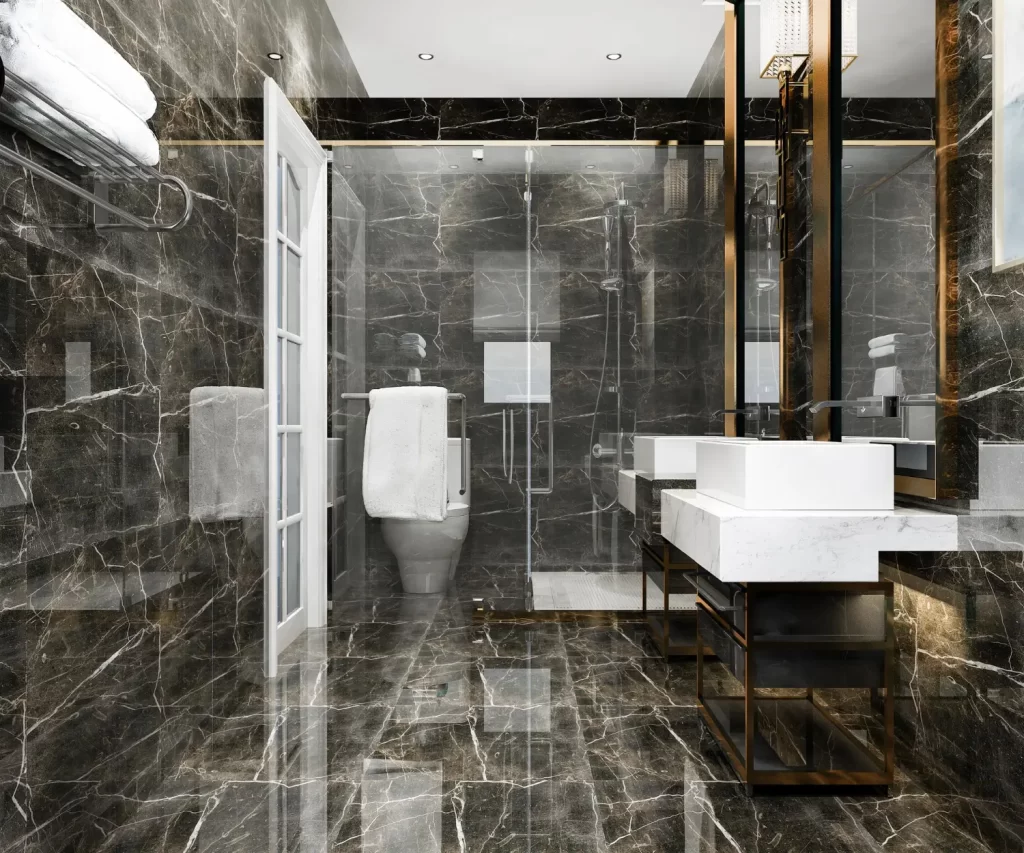A bathroom with black tiling and white fittings